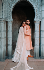 Load image into Gallery viewer, CELESTIAL OPULENCE: THE RESPLENDENT RICH CREAM TULLE SILK LEHENGA BY TANU KHERA DESIGNS"