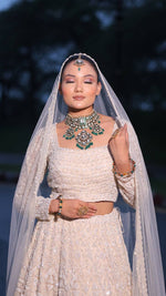 Load image into Gallery viewer, Ivory Opulence: Tanu Khera's Majestic Reception Lehenga with Exquisite Embroidery