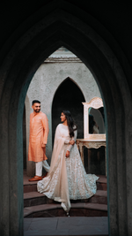 Load image into Gallery viewer, CELESTIAL OPULENCE: THE RESPLENDENT RICH CREAM TULLE SILK LEHENGA BY TANU KHERA DESIGNS&quot;
