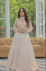 Load image into Gallery viewer, Majestic Splendor: Peach Net Lehenga with Sequins, Beads, Crystals, and Stone Embroidery
