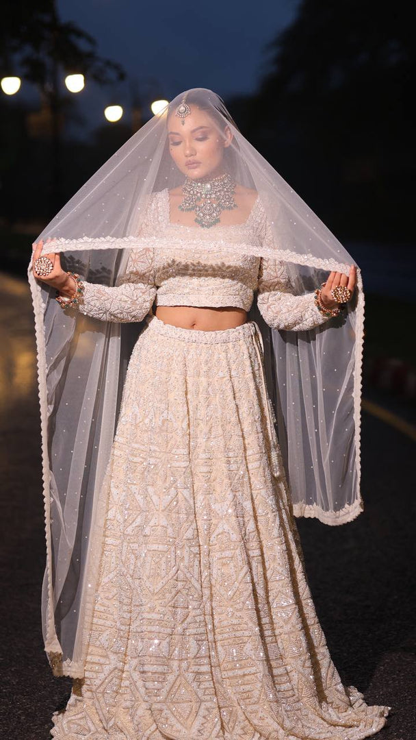 Ivory Opulence: Tanu Khera's Majestic Reception Lehenga with Exquisite Embroidery