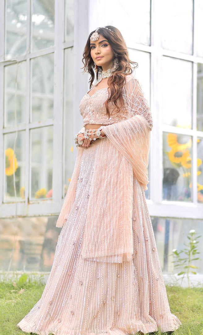 Majestic Splendor: Peach Net Lehenga with Sequins, Beads, Crystals, and Stone Embroidery