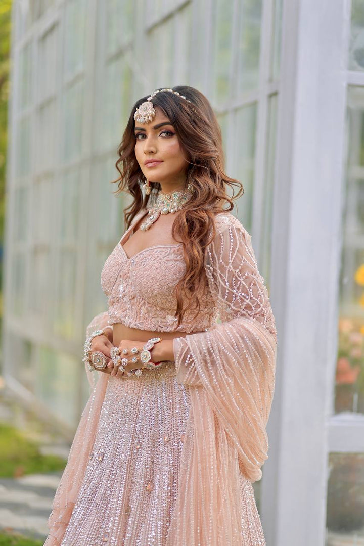 Majestic Splendor: Peach Net Lehenga with Sequins, Beads, Crystals, and Stone Embroidery